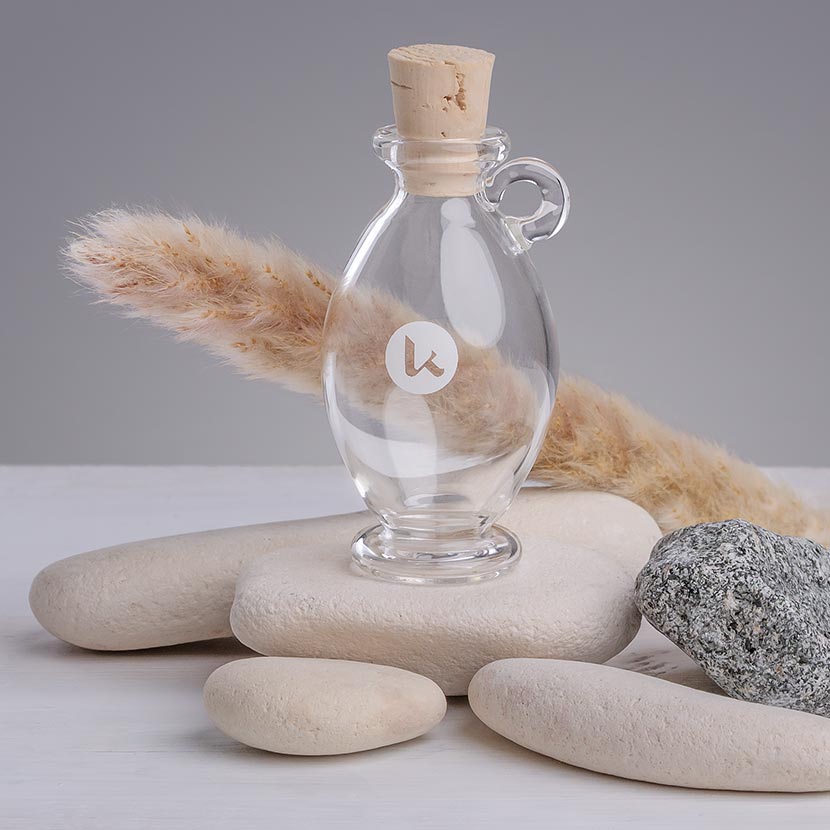Clear glass bottle in a hand-blown amphora style with cork closures