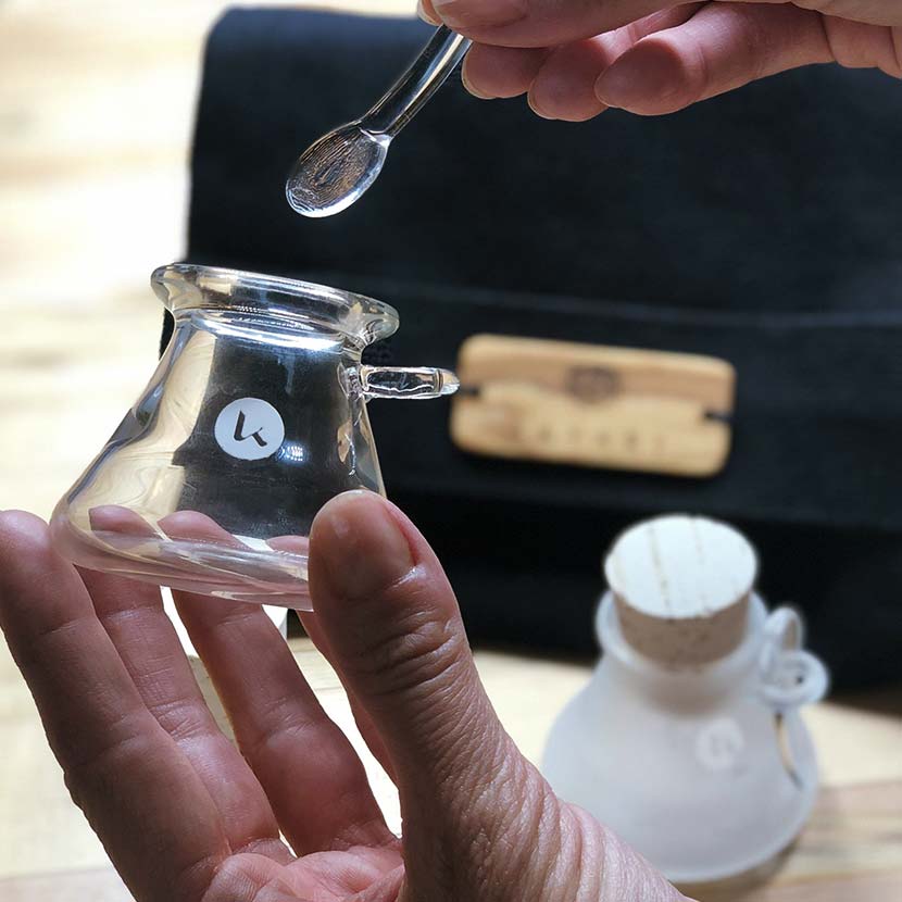 Hand blown artisanal glass jars in hand