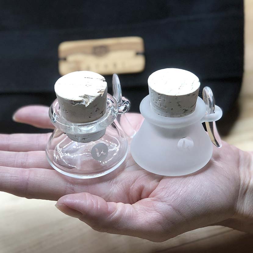 Heat resistant hand blown artisanal glass jars in hand