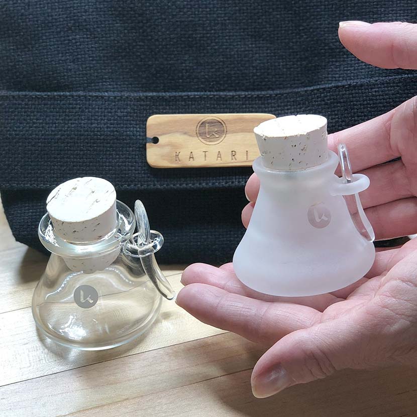 Heat resistant hand blown artisanal glass jars in hand