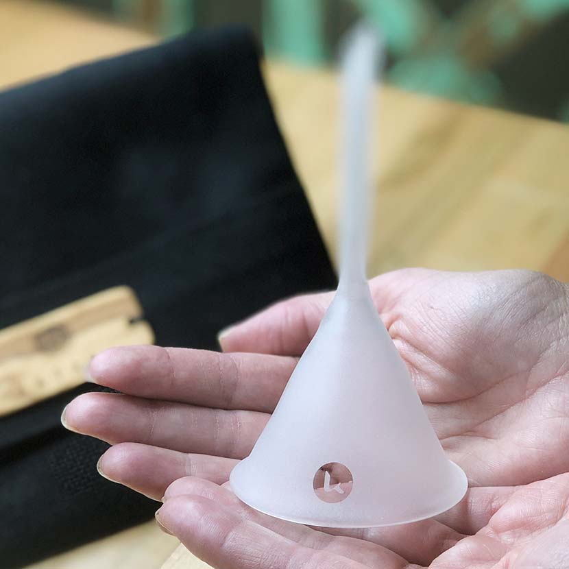Heat resistant hand blown artisanal glass funnel in hand