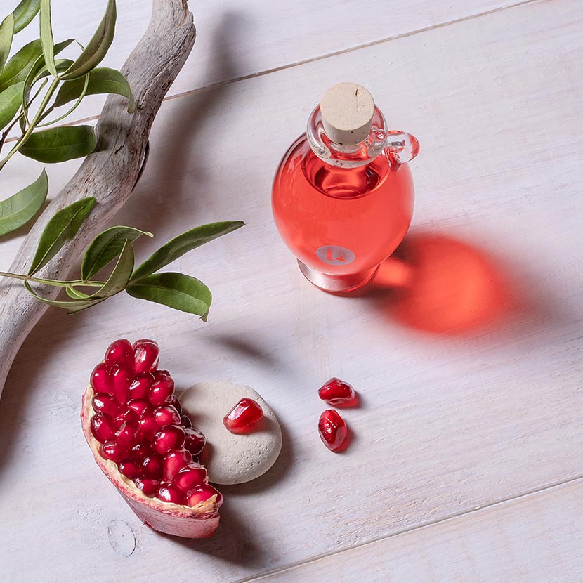 Cold-pressed pomegranate seed oil in a hand blown glass amphora - top view