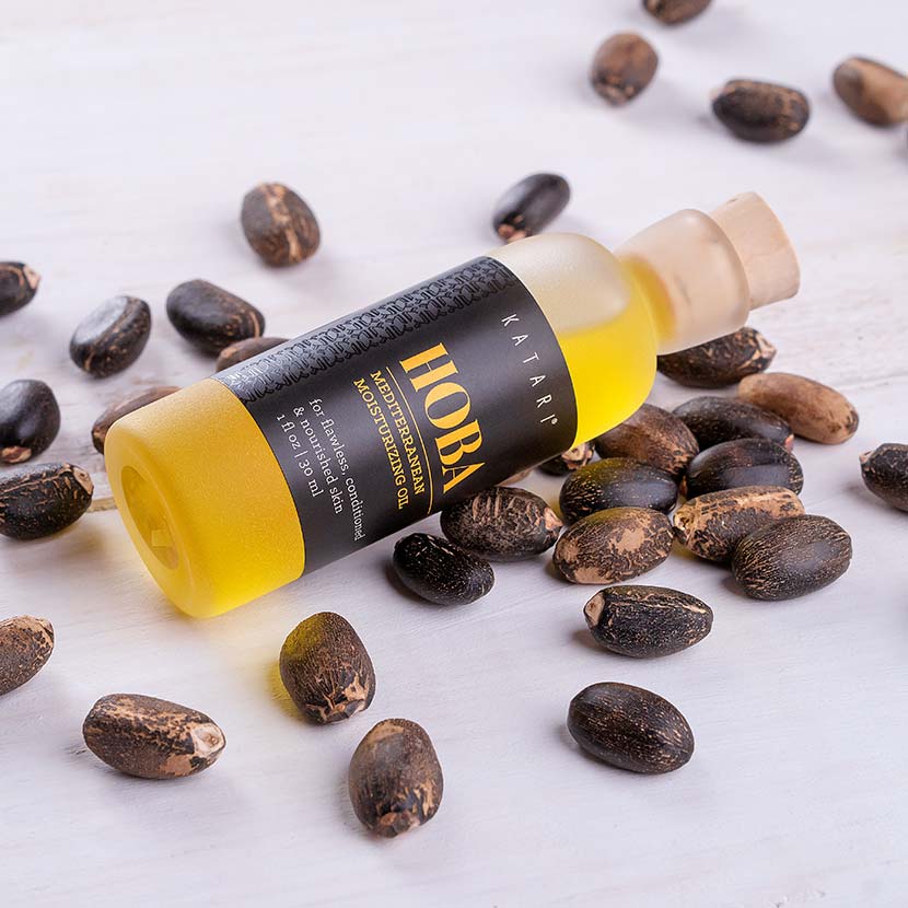 Bottle of jojoba oil with seeds